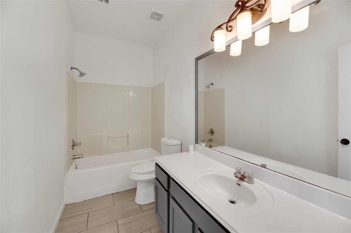 136 Shenandoah Trail Elgin, TX 78621 - Photo 14 of 27 a bathroom with a bathtub shower sink and toilet