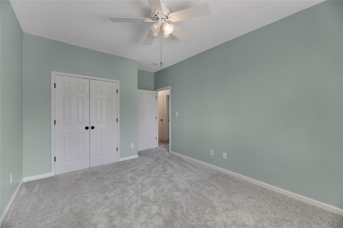 136 Shenandoah Trail Elgin, TX 78621 - Photo 16 of 27 an empty room with a ceiling fan and a window