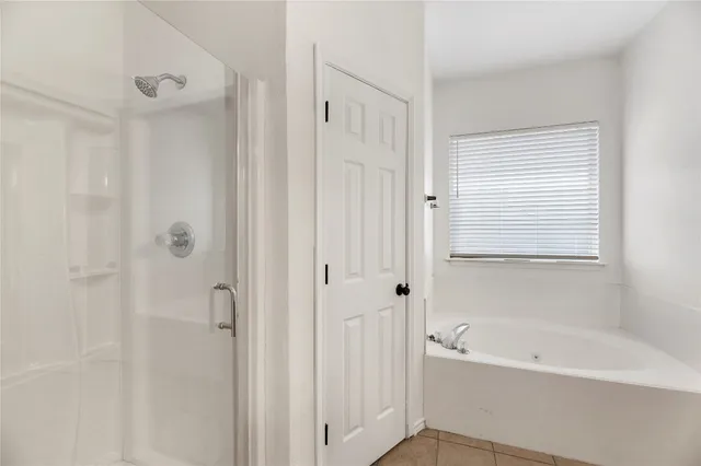 a bathroom with a bathtub shower and a sink