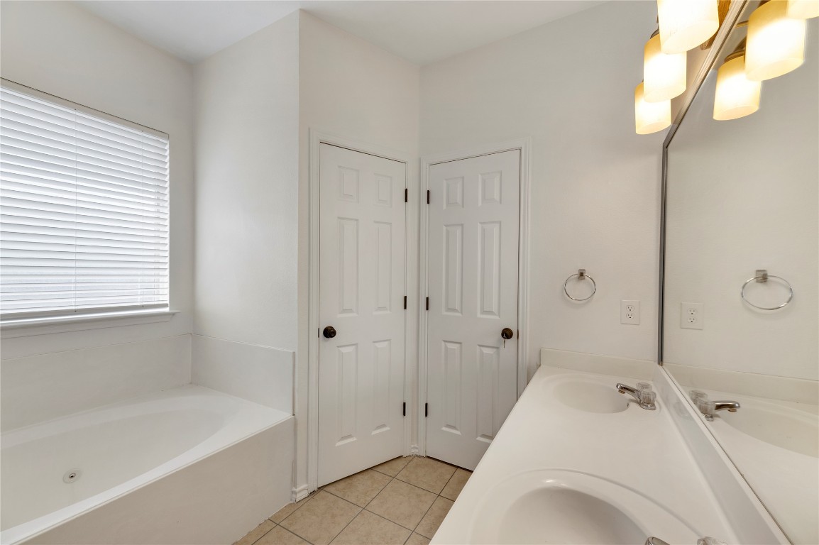 136 Shenandoah Trail Elgin, TX 78621 - Photo 23 of 27 a spacious bathroom with a tub shower and sink