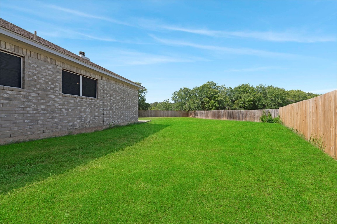 136 Shenandoah Trail Elgin, TX 78621 - Photo 26 of 27 a view of a backyard with a garden