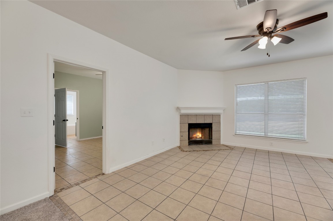 136 Shenandoah Trail Elgin, TX 78621 - Photo 3 of 27 a view of an empty room with a fireplace and a window