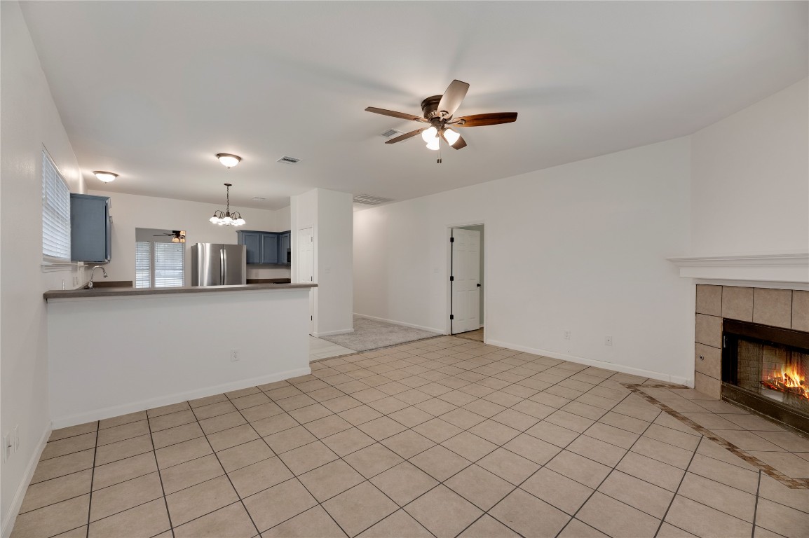136 Shenandoah Trail Elgin, TX 78621 - Photo 4 of 27 a view of an empty room and kitchen with fireplace