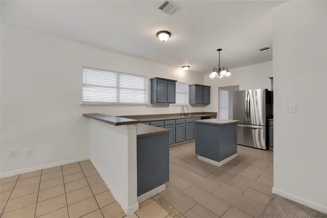 a kitchen with stainless steel appliances a refrigerator sink and microwave