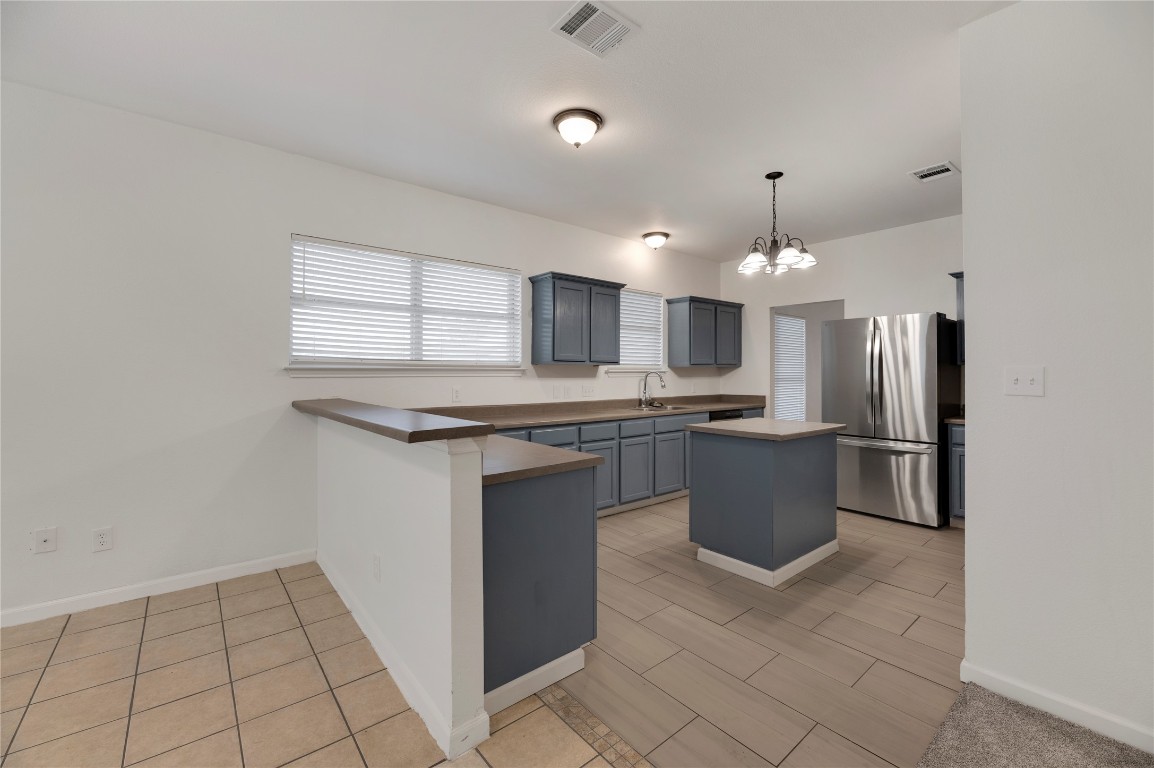 136 Shenandoah Trail Elgin, TX 78621 - Photo 5 of 27 a kitchen with stainless steel appliances a refrigerator sink and microwave