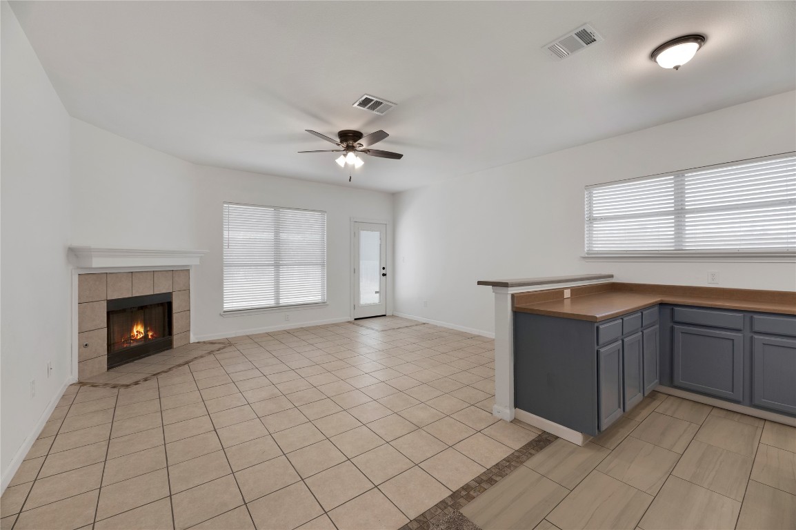 136 Shenandoah Trail Elgin, TX 78621 - Photo 6 of 27 a view of an empty room with a fireplace and a window