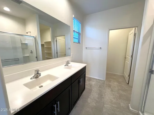 a bathroom with a double vanity sink and a mirror
