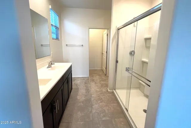 a bathroom with a glass door shower