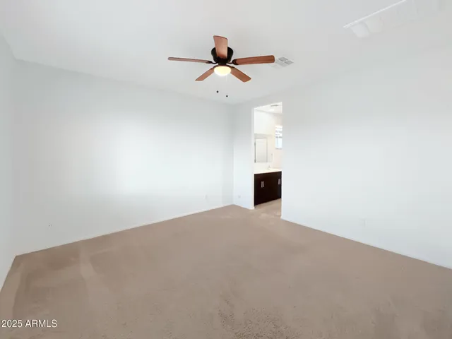 a view of a room with a ceiling fan and a window
