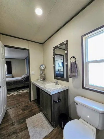 a bathroom with a toilet sink and mirror