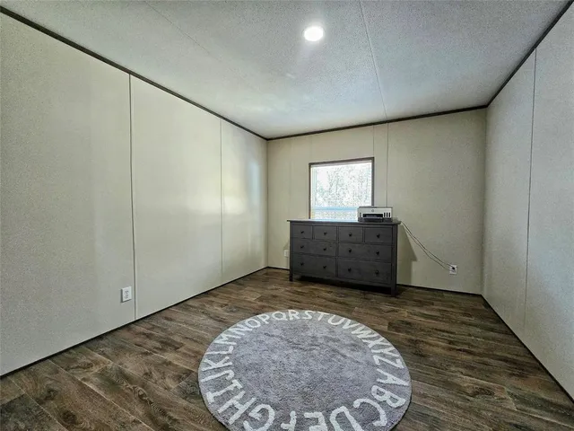 an empty room with a rug