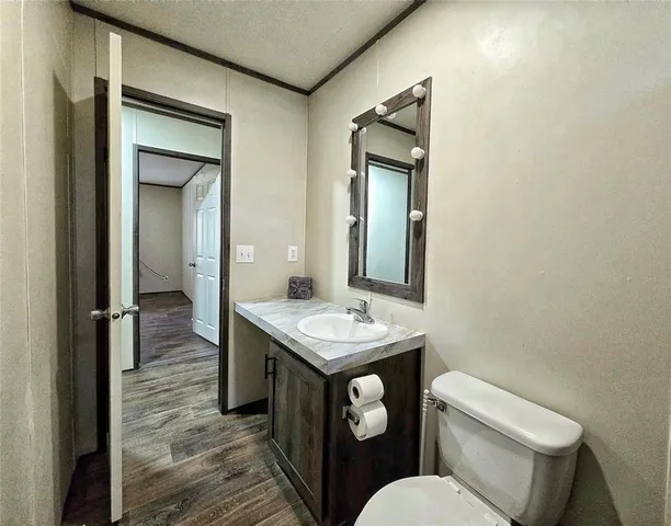 a bathroom with a toilet sink and mirror