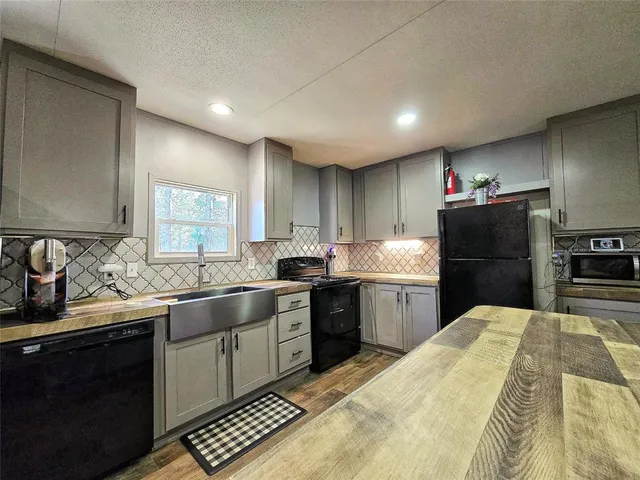 a kitchen with a sink stove and refrigerator