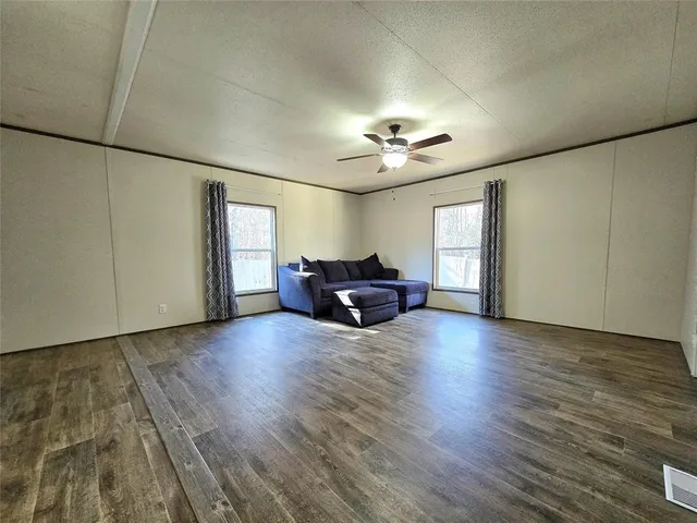 a living room with furniture and chandelier