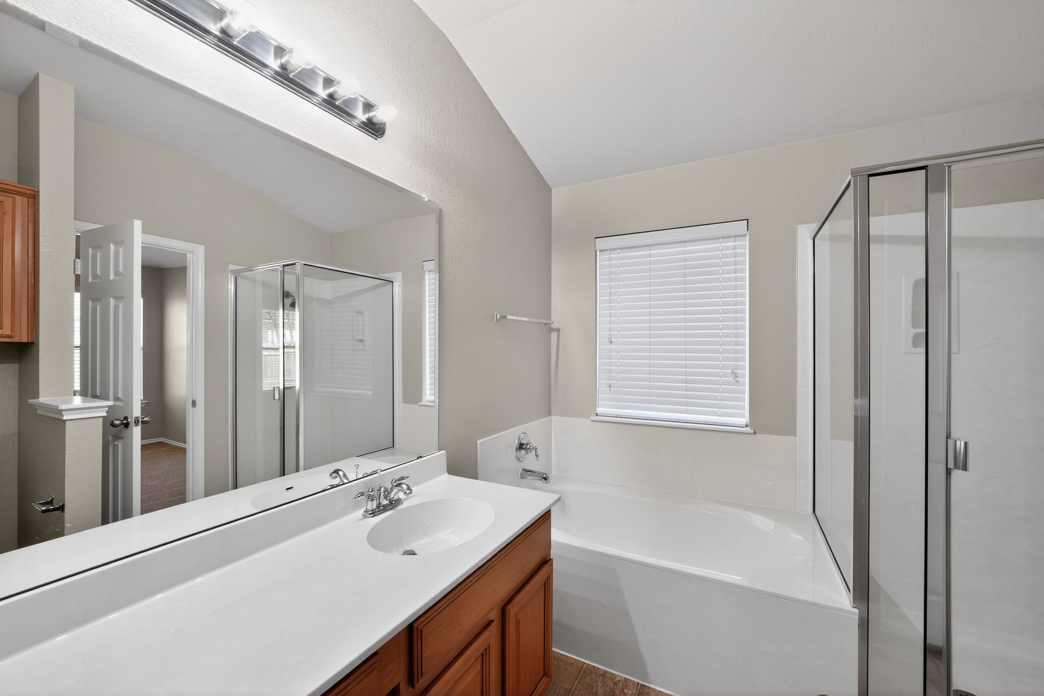 1007 Gentry Drive Leander, TX 78641 - Photo 23 of 35 a bathroom with a tub sink and mirror