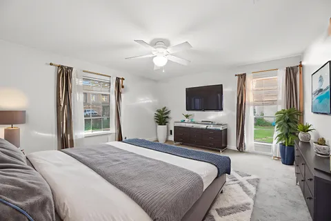 a bedroom with a bed and a flat screen tv