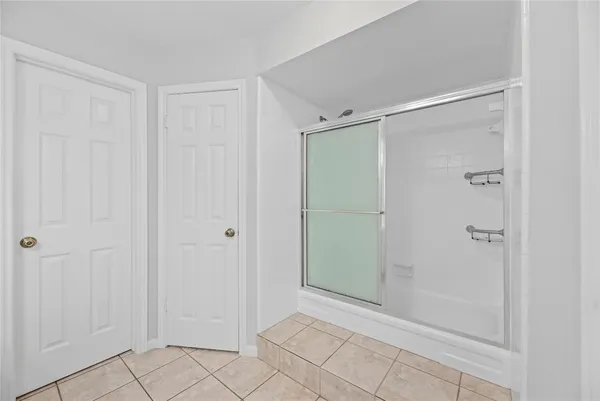 a spacious bathroom with a double vanity sink a mirror and a bathtub