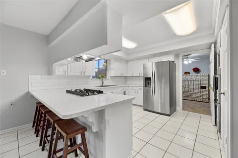 a kitchen that has a table and chairs in it