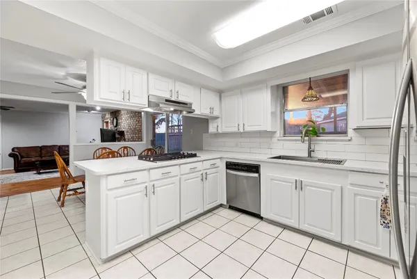 a kitchen that has a table and chairs in it