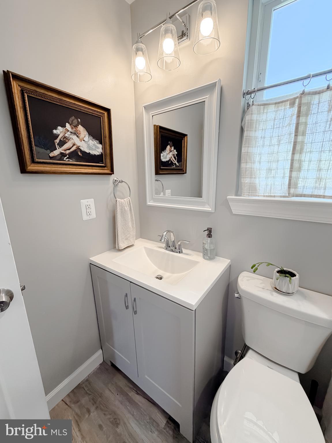 4985 Solomons Island Road Huntingtown, MD 20639 - Photo 31 of 50 a bathroom with a toilet a sink and mirror