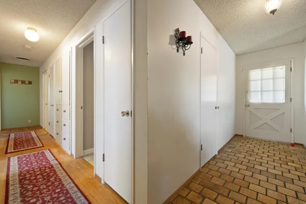 a view of a bedroom with wooden floor and windows