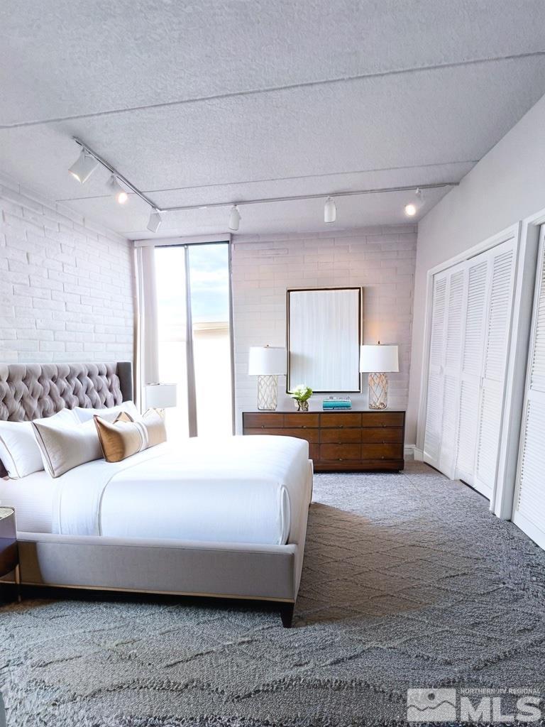 1200 Riverside Drive, Unit 1239 Reno, NV 89503 - Photo 20 of 35 a spacious bedroom with a bed and a large window