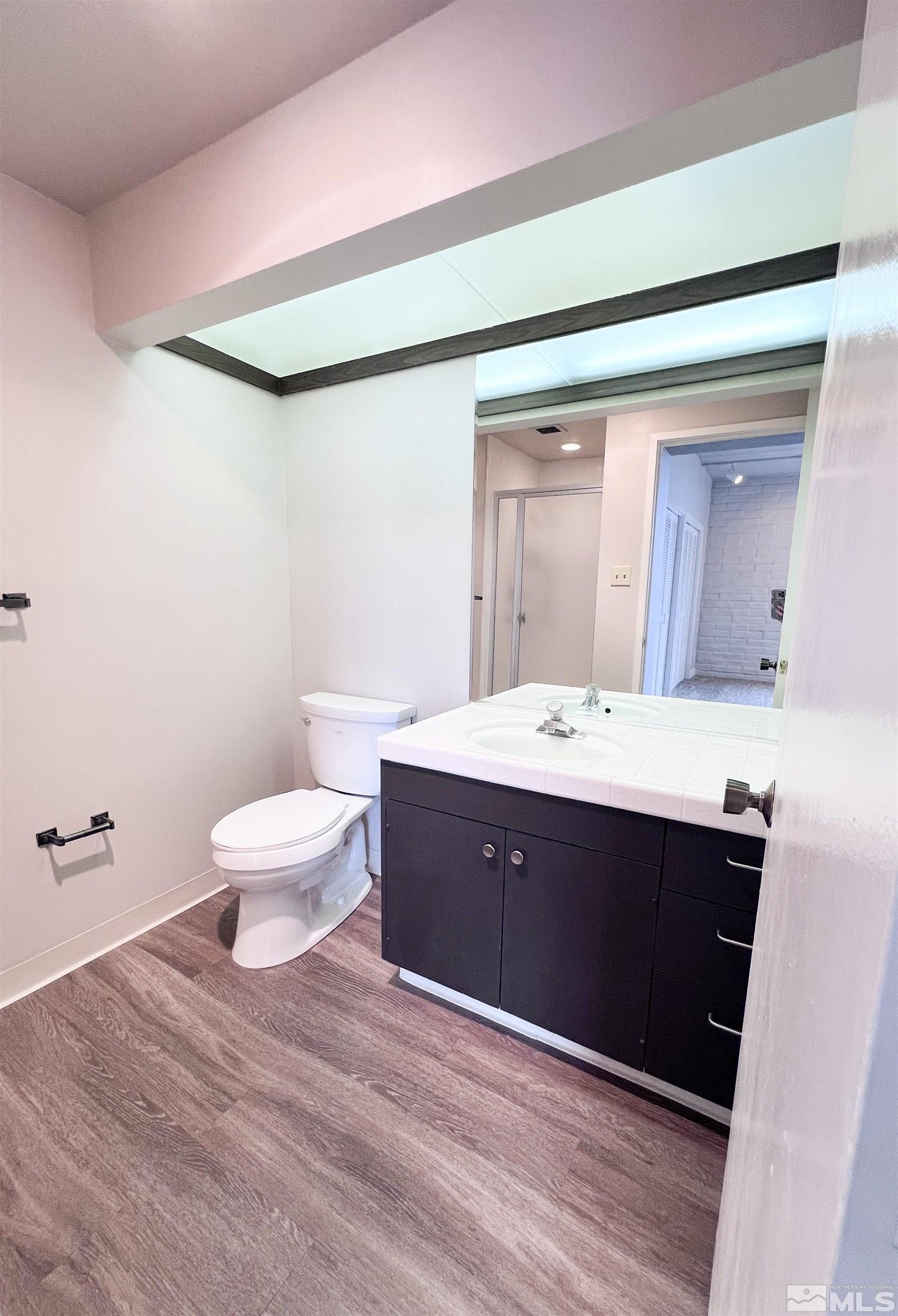 1200 Riverside Drive, Unit 1239 Reno, NV 89503 - Photo 21 of 35 a spacious bathroom with a double vanity sink toilet and a mirror