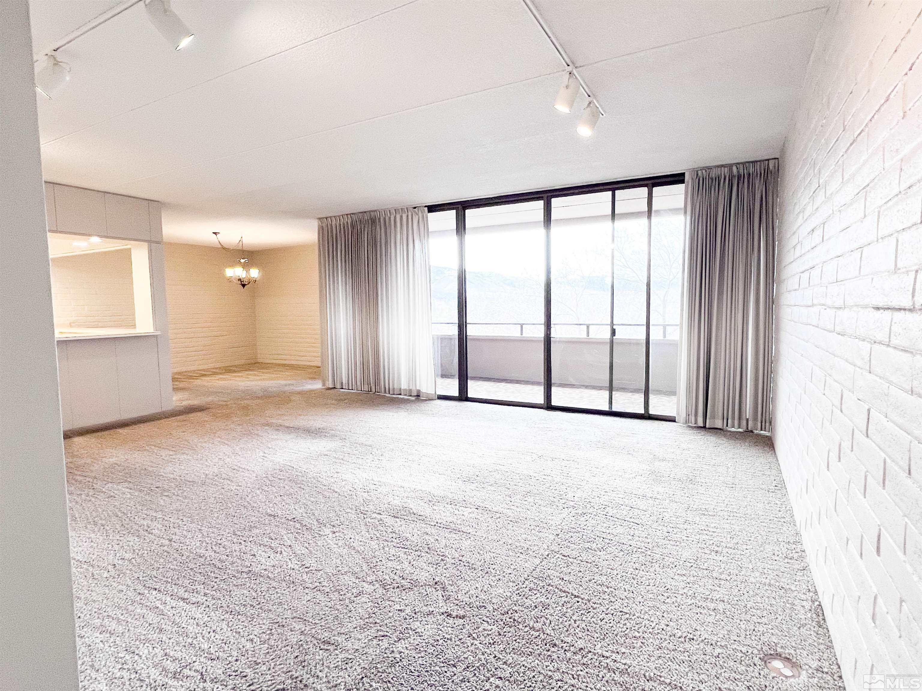 1200 Riverside Drive, Unit 1239 Reno, NV 89503 - Photo 6 of 35 an empty room with a empty space and windows