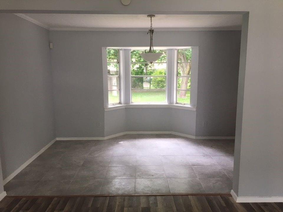 a view of an empty room with windows and outdoor view