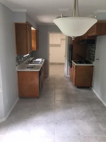 a kitchen with kitchen island cabinets and window