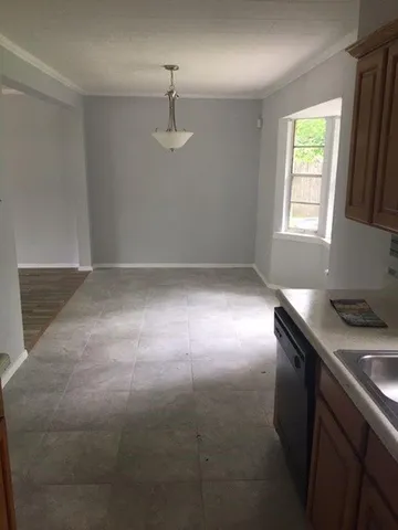 a kitchen that has a sink a stove and a window