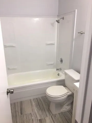 a bathroom with a toilet and a shower