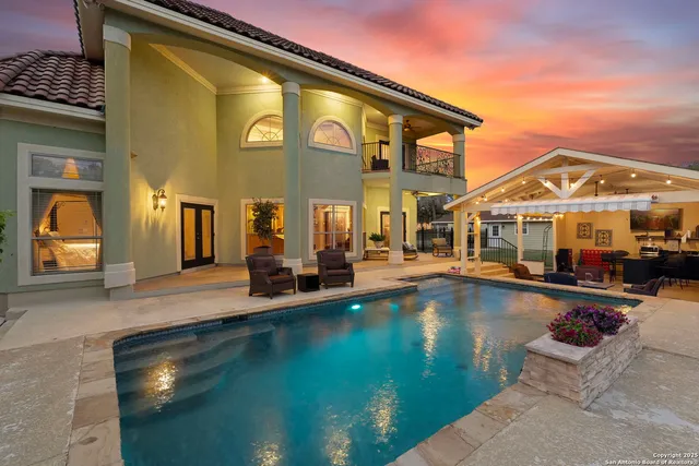 a view of a house with pool and chairs
