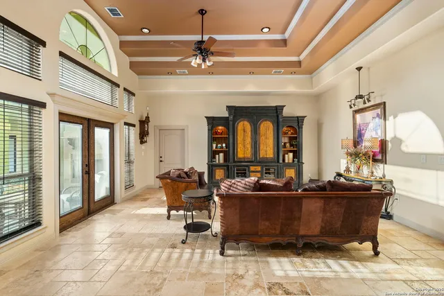 a living room with furniture a large window and a rug