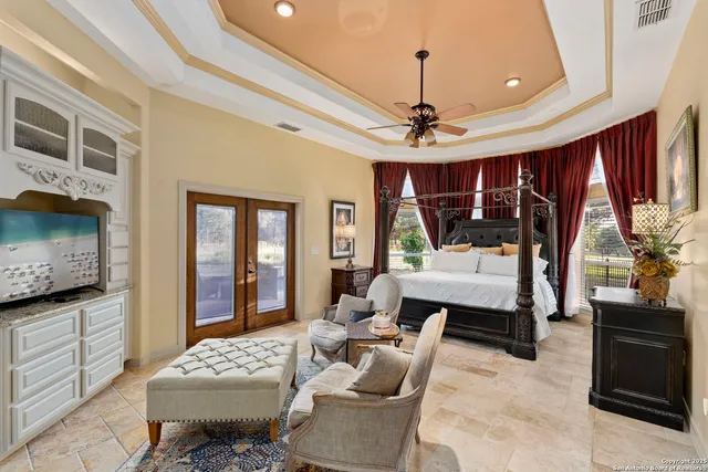 a bedroom with a bed and a large mirror with a flat tv screen