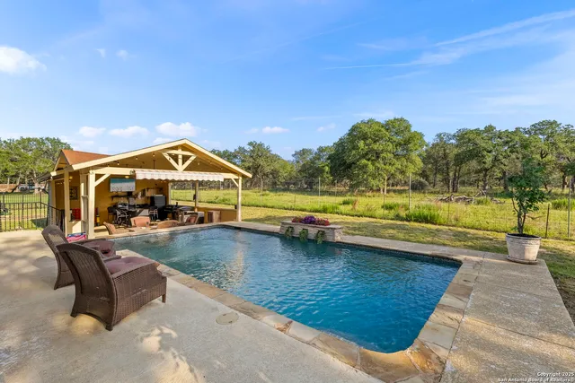 a outdoor space with patio the couches and a fireplace