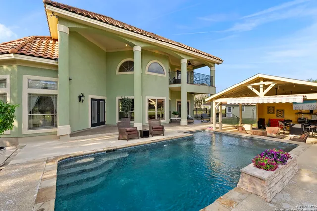 a view of a house with backyard and sitting area
