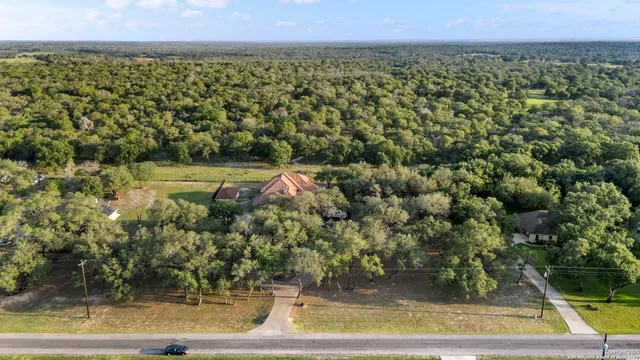 an aerial view of a house with a yard lake view