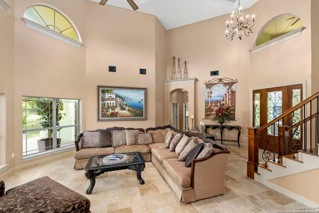 a living room with fireplace furniture and a large window