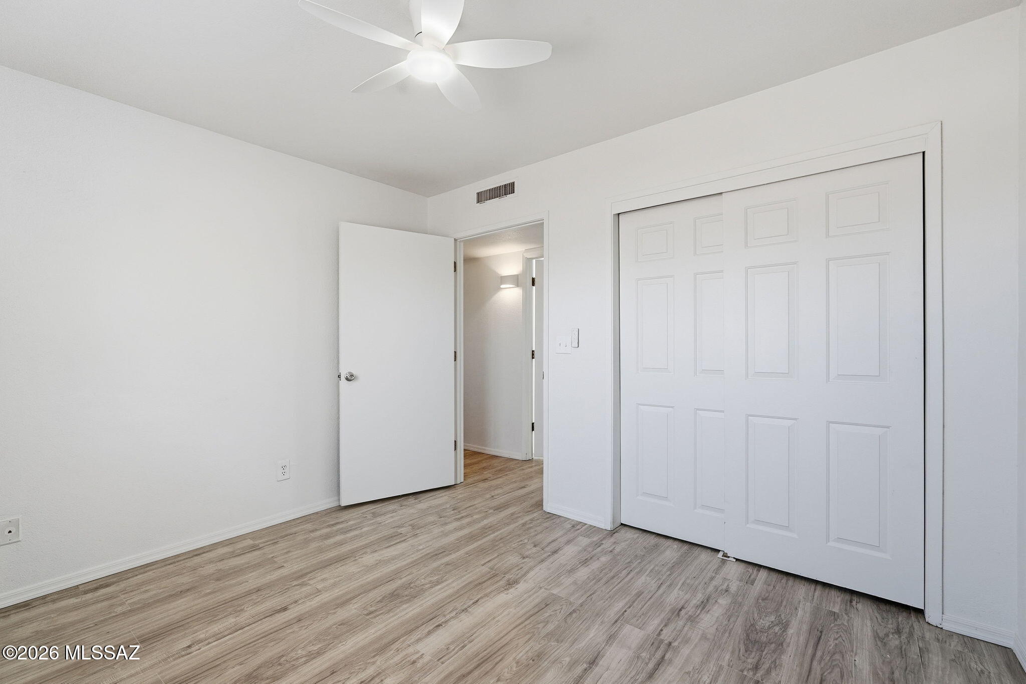 136 West Elvira Road Tucson, AZ 85756 - Photo 18 of 27 a view of an empty room with wooden floor
