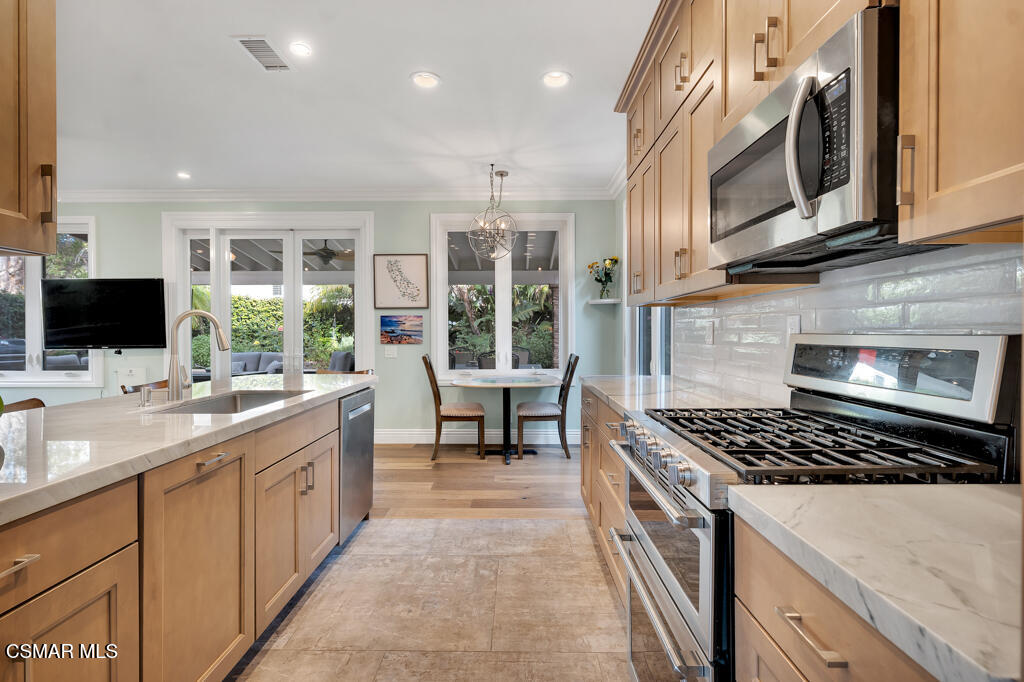 11177 Terraceridge Road Moorpark, CA 93021 - Photo 19 of 54 a kitchen with stainless steel appliances a sink dishwasher stove microwave and cabinets
