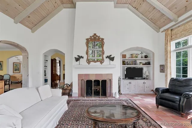 a view of a dining room with furniture a chandelier and window