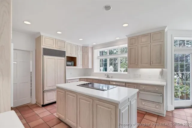 a bedroom with a bed couch and windows