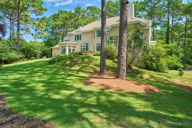a living room with furniture a fireplace and a chandelier