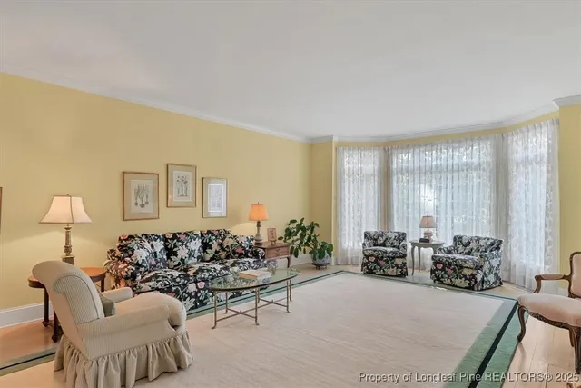 a living room with furniture fireplace and a large window