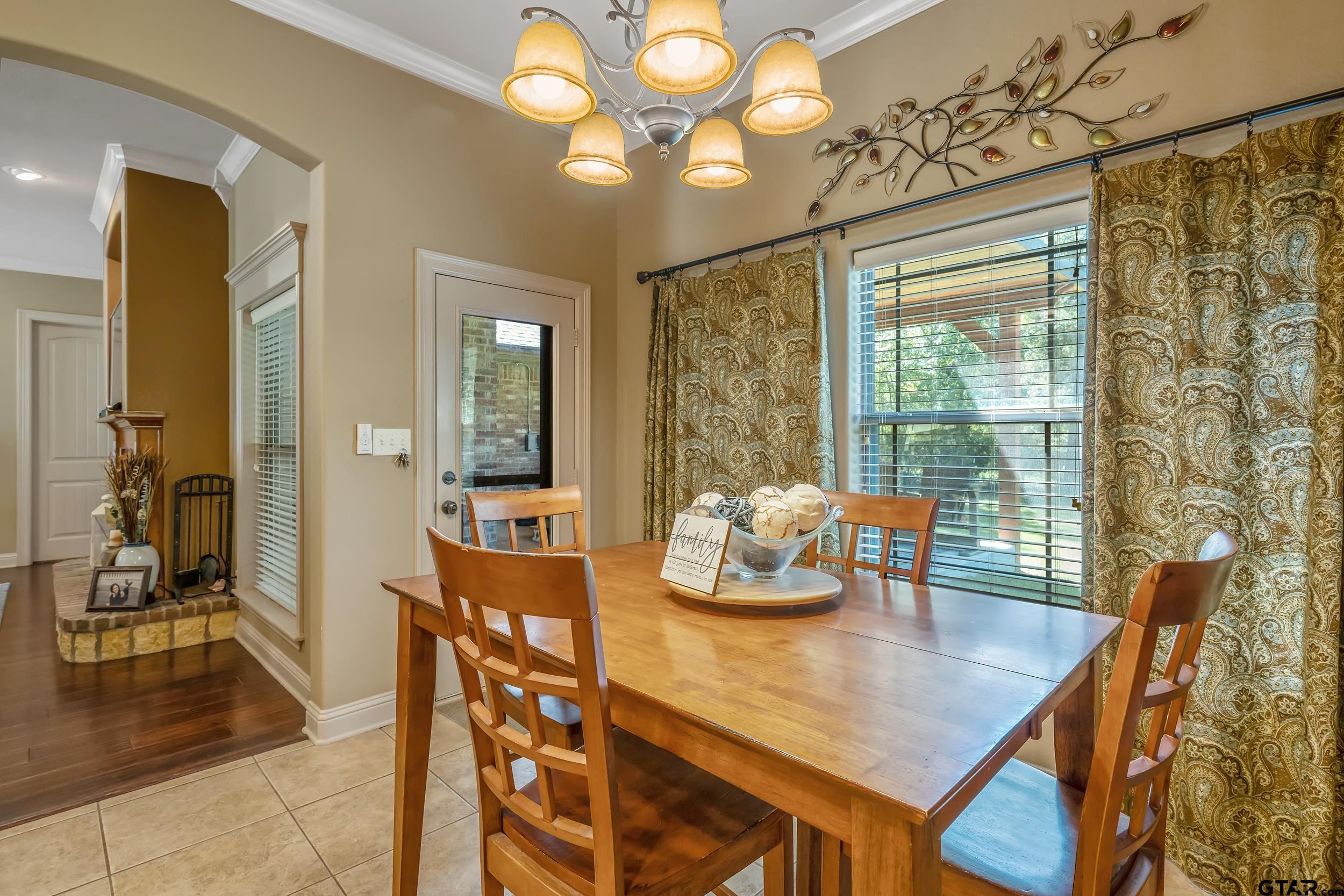 140 Creek Drive Marshall, TX 75672 - Photo 11 of 35 a view of a dining room with furniture and wooden floor
