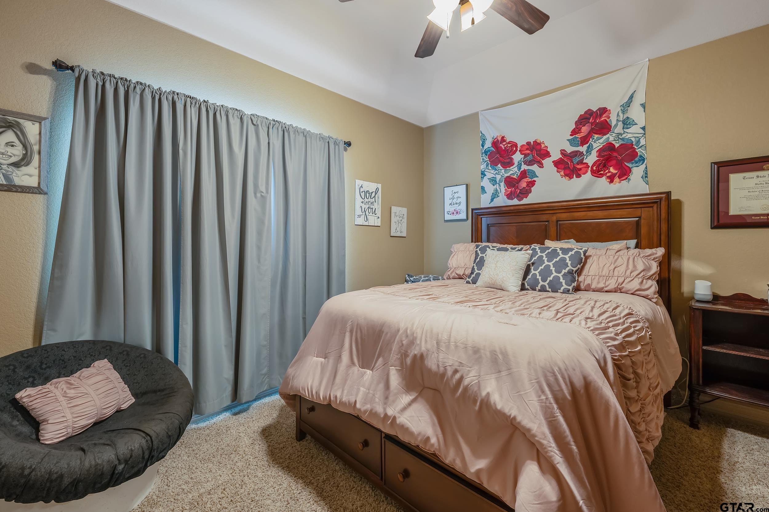 140 Creek Drive Marshall, TX 75672 - Photo 12 of 35 a bedroom with a bed and a chandelier