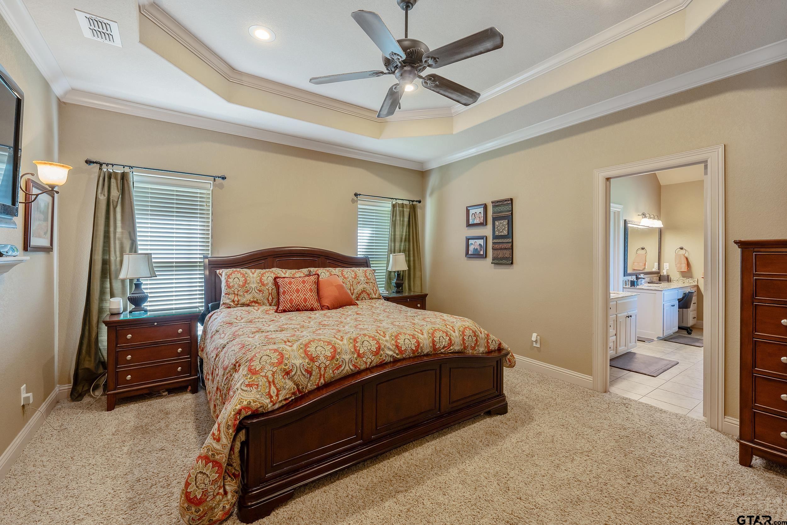 140 Creek Drive Marshall, TX 75672 - Photo 17 of 35 a bedroom with a bed and a view of bathroom