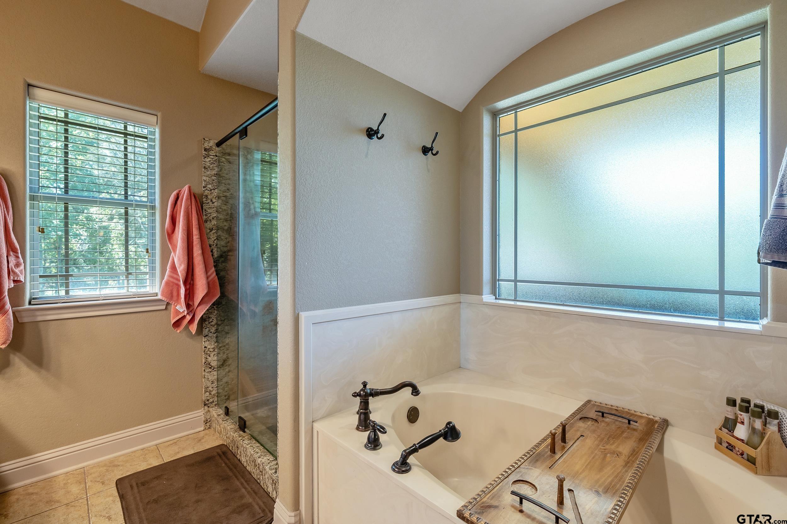 140 Creek Drive Marshall, TX 75672 - Photo 20 of 35 a bathroom with a tub and a shower