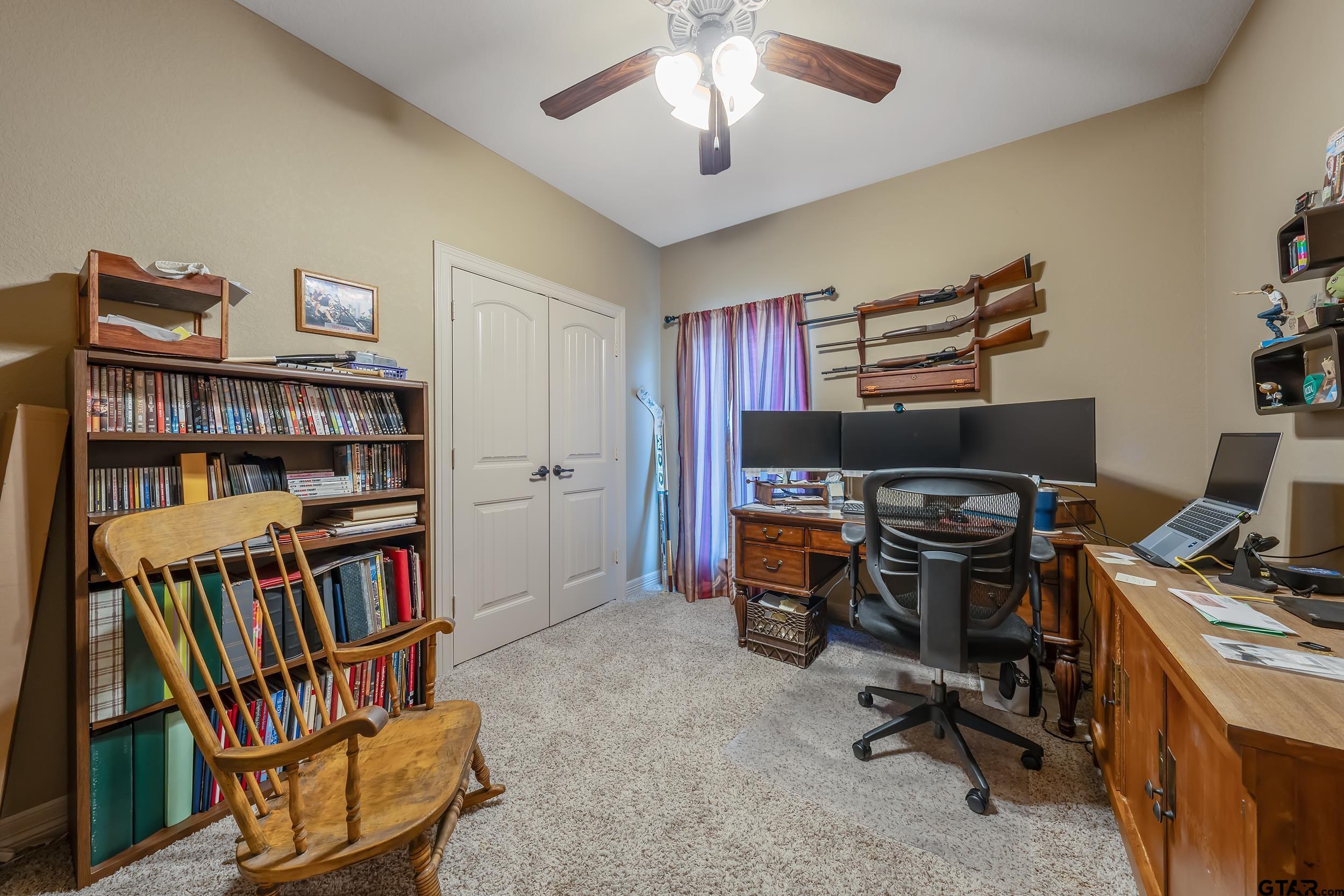 140 Creek Drive Marshall, TX 75672 - Photo 21 of 35 a view of a workspace with furniture and a bookshelf